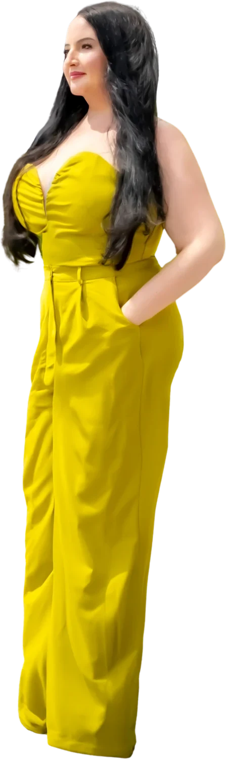 Deborah Feathers in a yellow jumpsuit, standing in downtown Miami